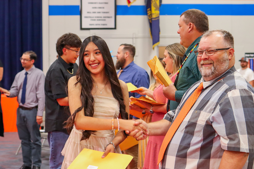 Student shaking hands with Mr. Coyle 