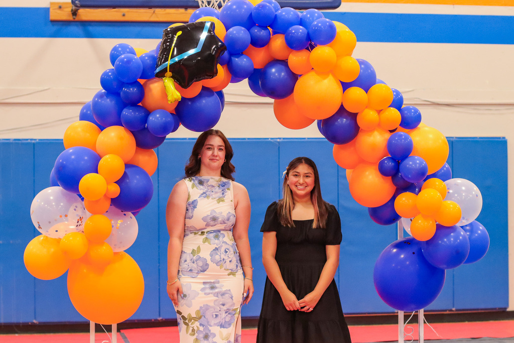Students standing under balloon arch