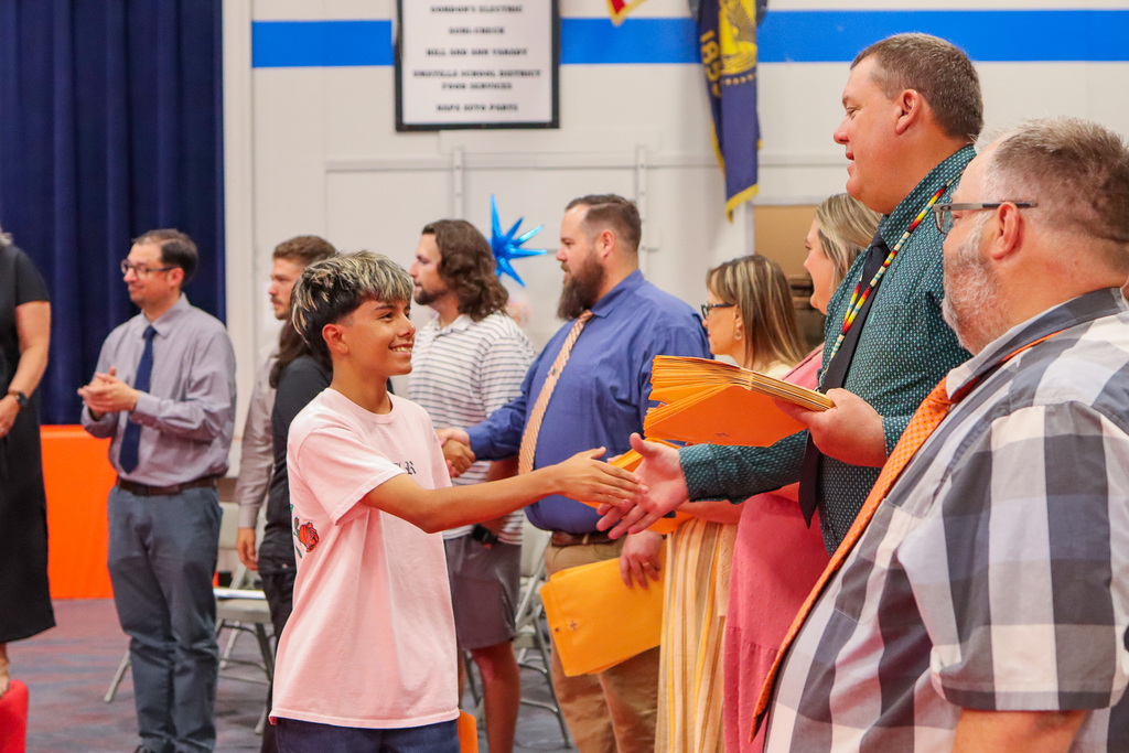 Student shaking hands with Mr. Durfey