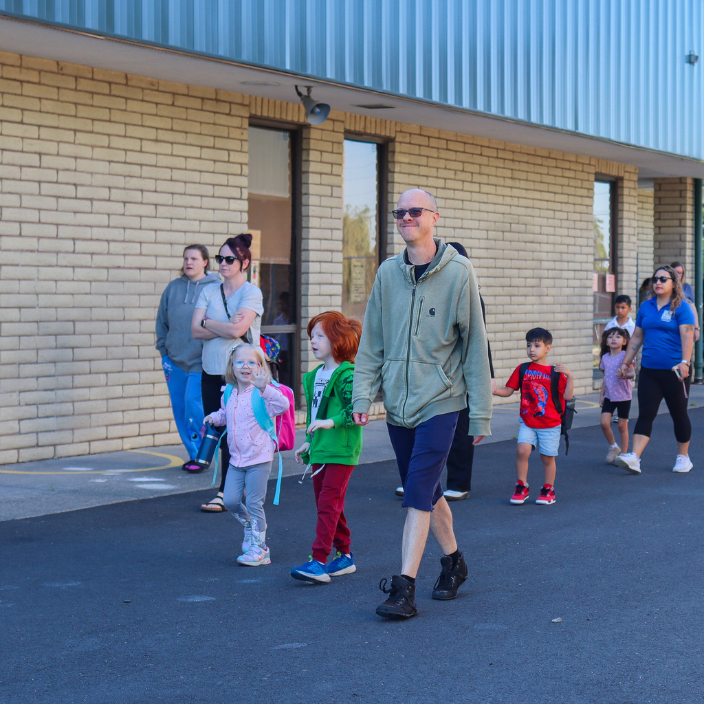 families walking their student to the playground