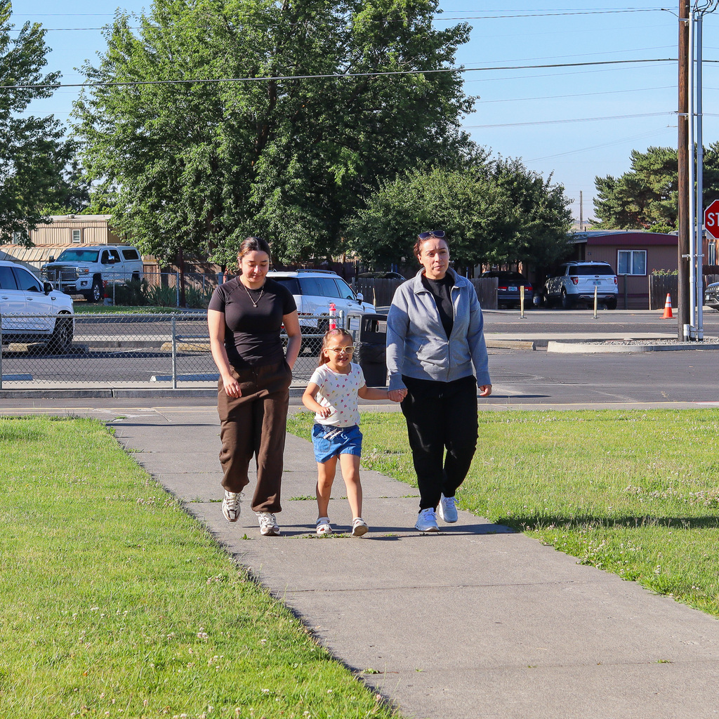 Family walking with student to playground