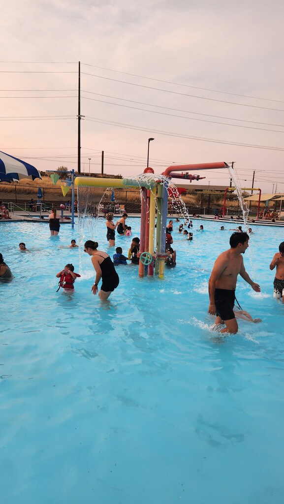 families and students enjoying the pool