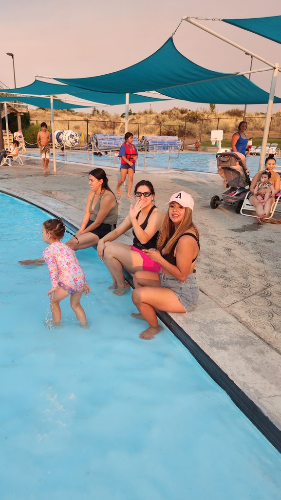 families sitting on the edge of the pool