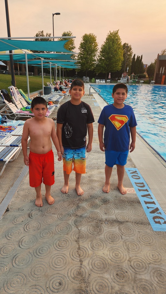 students standing next to the pool