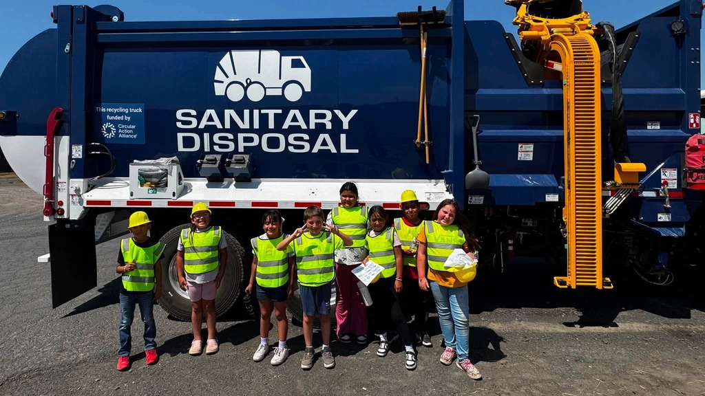 Photo of students in front of sanitary disposal truck