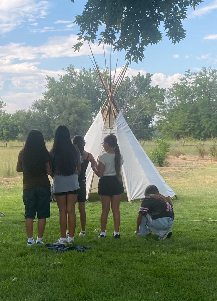 students looking at teepee