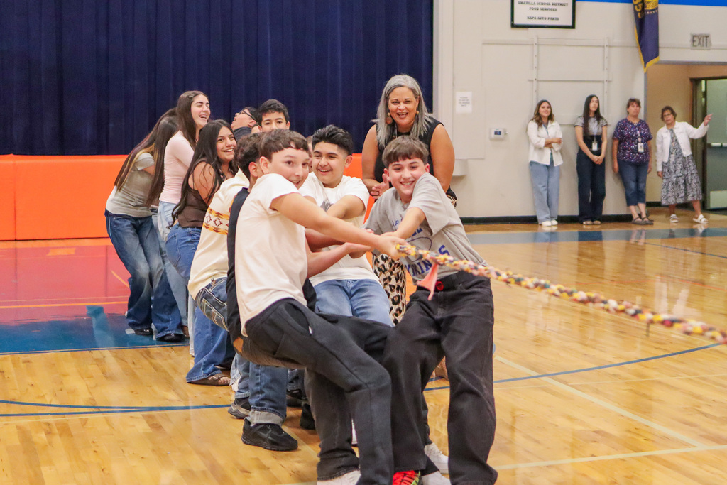 Mrs. Chase's middle school students battling against another advisory teacher's class in a game of Tug-A-War at welcome back assembly