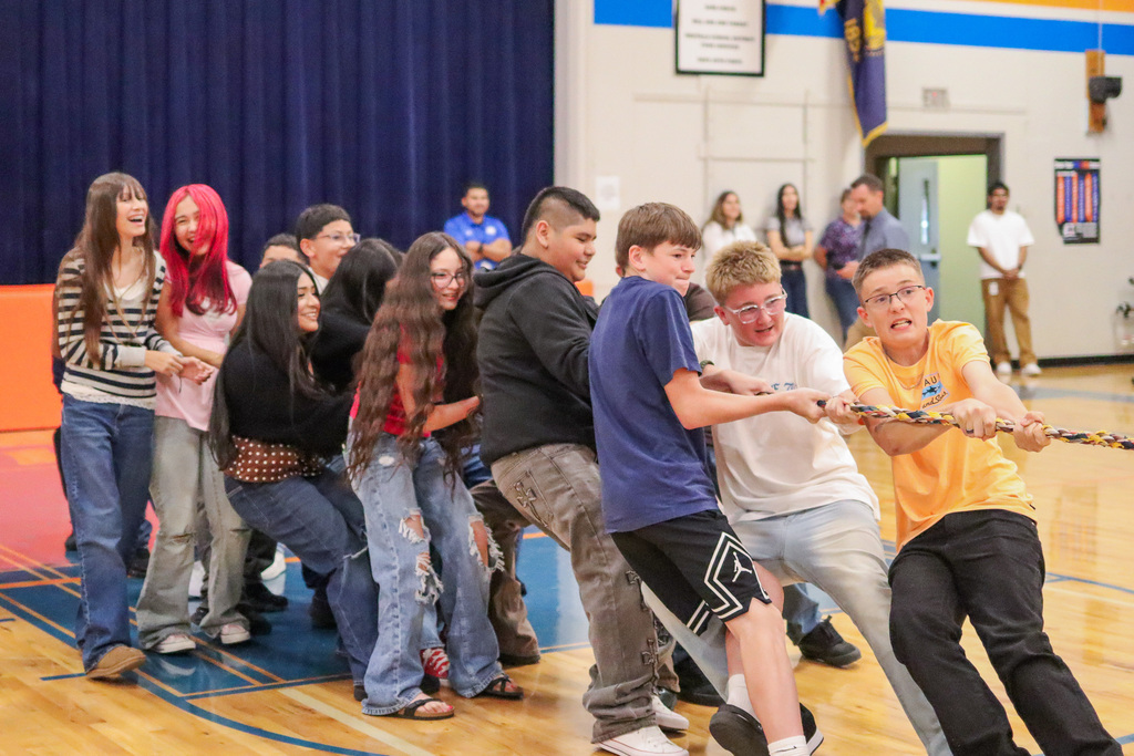 Middle school students battling against each other in a game of Tug-A-War at the welcome back assembly 