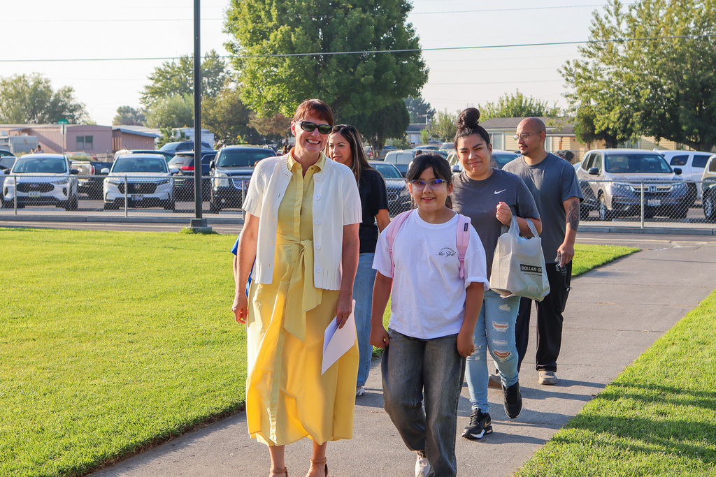 Superintendent Sipe walking student to classroom on first day of school 