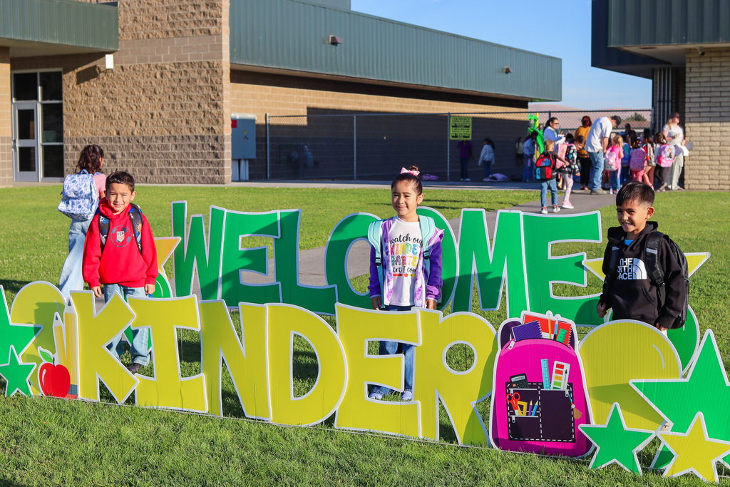 Photo of kinder with "Welcome Kinder" Card my Yard Sign