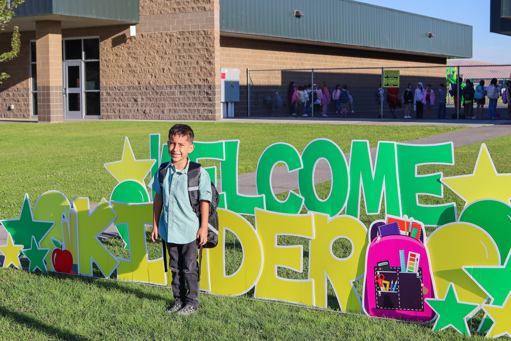 Photo of kinder with "Welcome Kinder" Card my Yard Sign