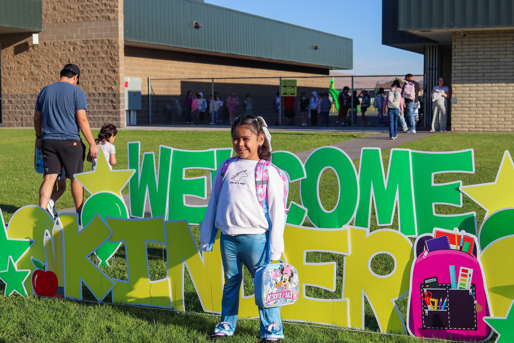 Photo of kinder with "Welcome Kinder" Card my Yard Sign
