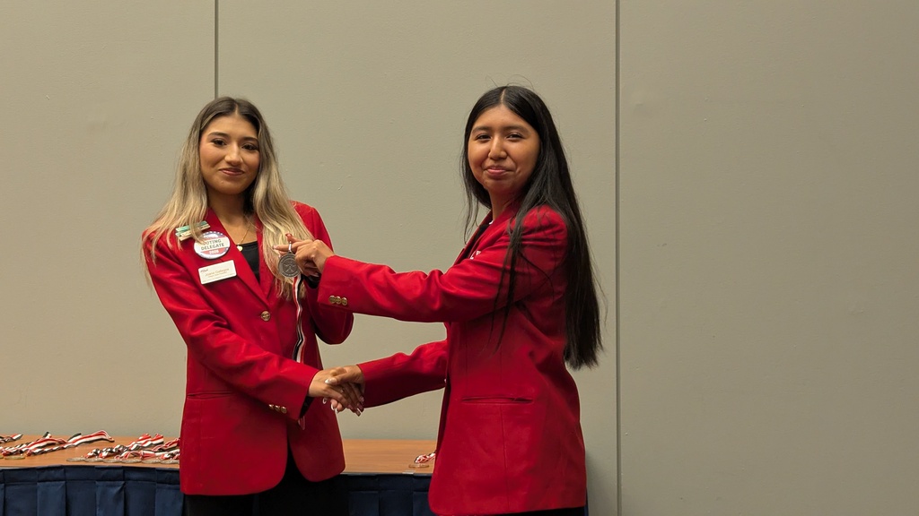 Joana awarding Cindy silver medal for her project