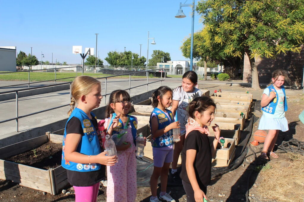 Girl Scout troop getting ready to plant seeds in the garden 