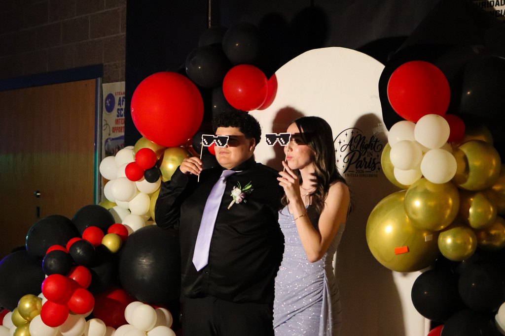 students taking a picture at the photo booth during the homecoming game