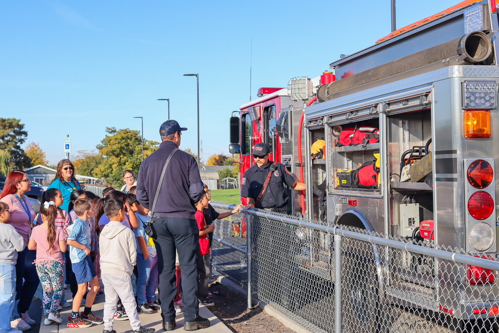 Umatilla Firefighter showing students the tools they use to fight fires