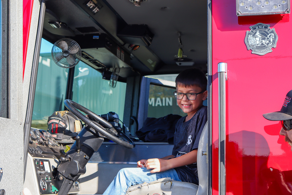 Sitting sitting in the drivers seat of the fire truck