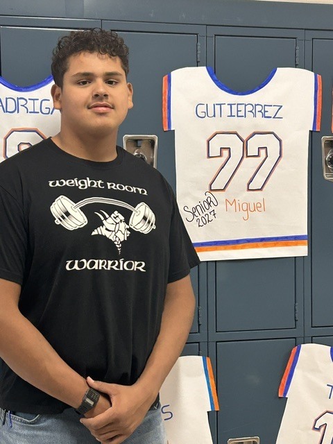 Senior with banner of their jersey