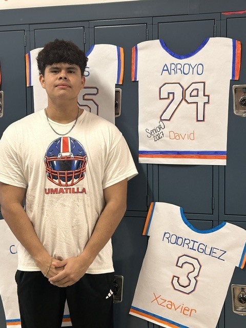 Senior with banner of their jersey