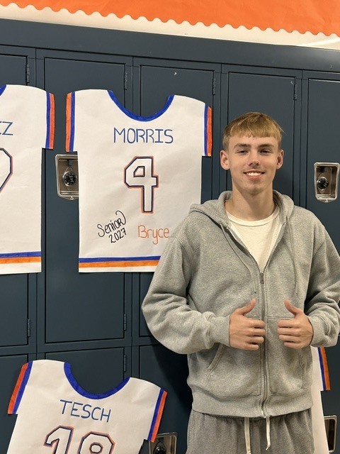 Senior with banner of their jersey