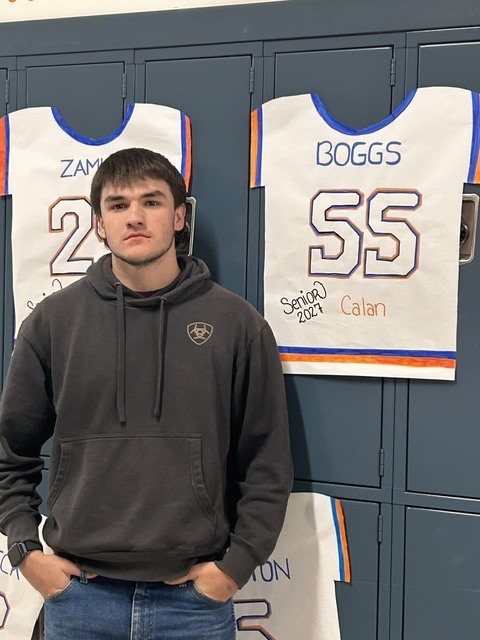 Senior with banner of their jersey