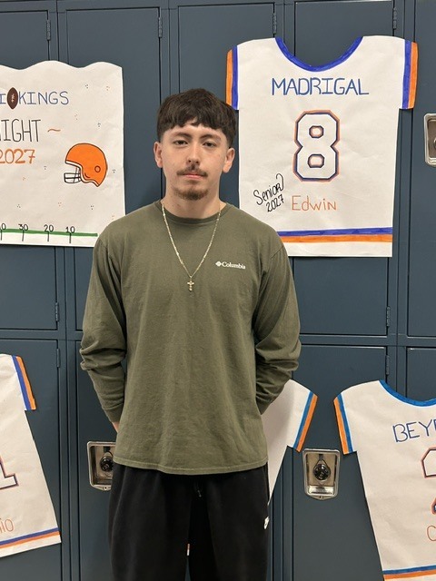 Senior with banner of their jersey