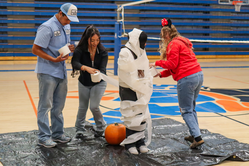 UHS students wrapping another student up in toilet paper to look like a mummy