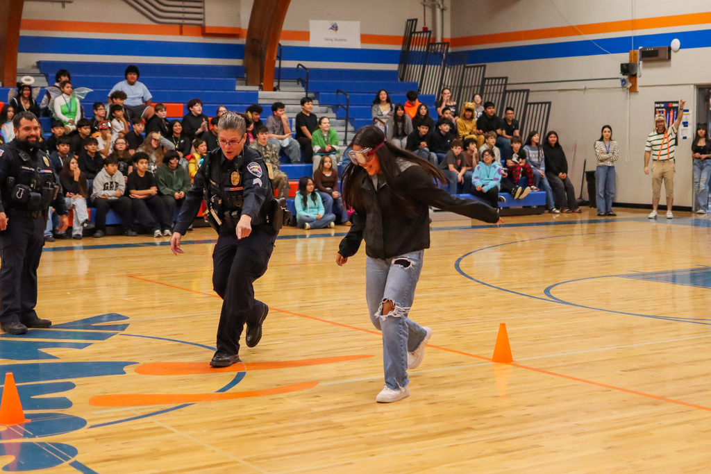 Officer Tovey directing student where to run in the CBMS relay race