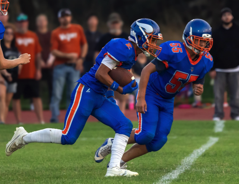 Photo by Kathy Aney. Umatilla's Isaac Cortes (2) runs the ball and Kristian Johnston (55) blocks while playing Irrigon on Sept. 5, 2025 in Umatilla 