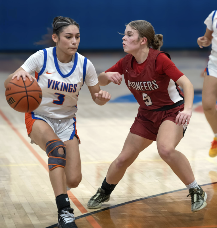Photo by Kathy Aney Umatilla's EvaLynn Campos (3) attempts to navigate past McLoughlin's Ella Burwell on Jan. 17, 2026, in Umatilla.
