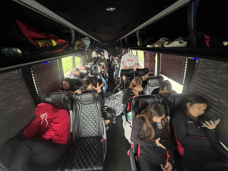 students in charter bus heading to season opener football game