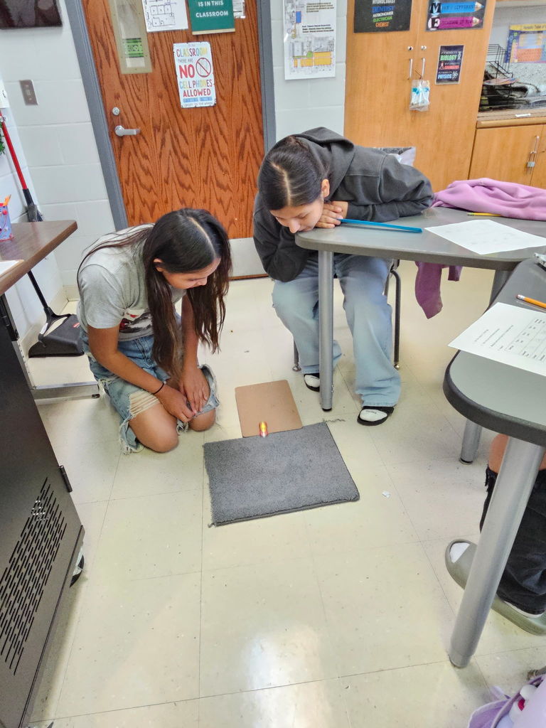 8th-grade students are all hands on when it comes to learning.  Here they are conducting a forces and motion lab while learning about friction.