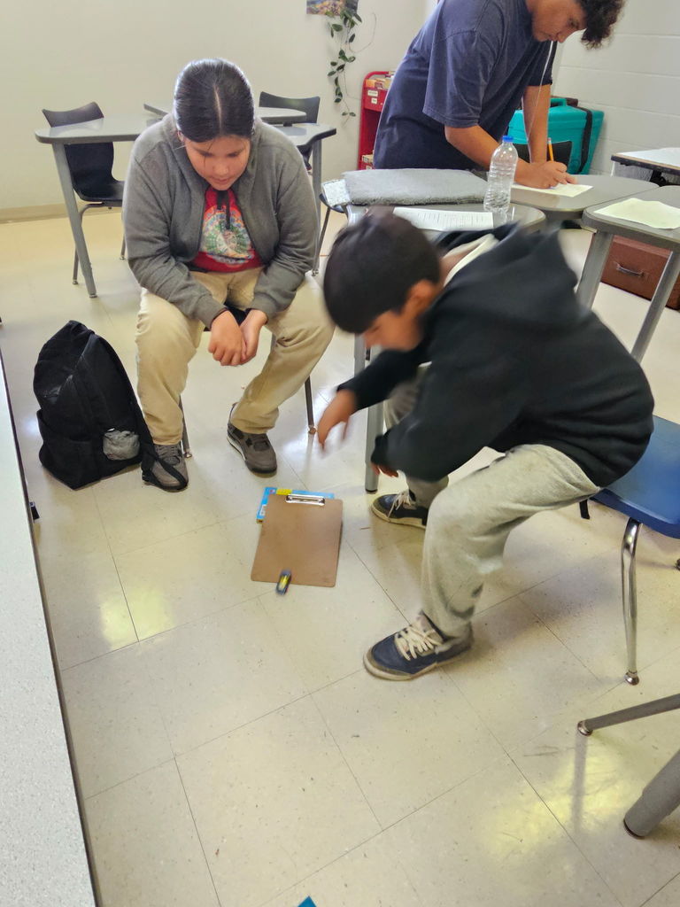 8th-grade students are all hands on when it comes to learning.  Here they are conducting a forces and motion lab while learning about friction.