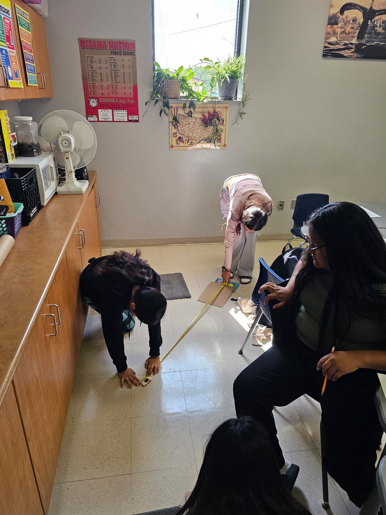 8th-grade students are all hands on when it comes to learning.  Here they are conducting a forces and motion lab while learning about friction.