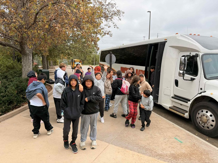 field trip students in front of bus