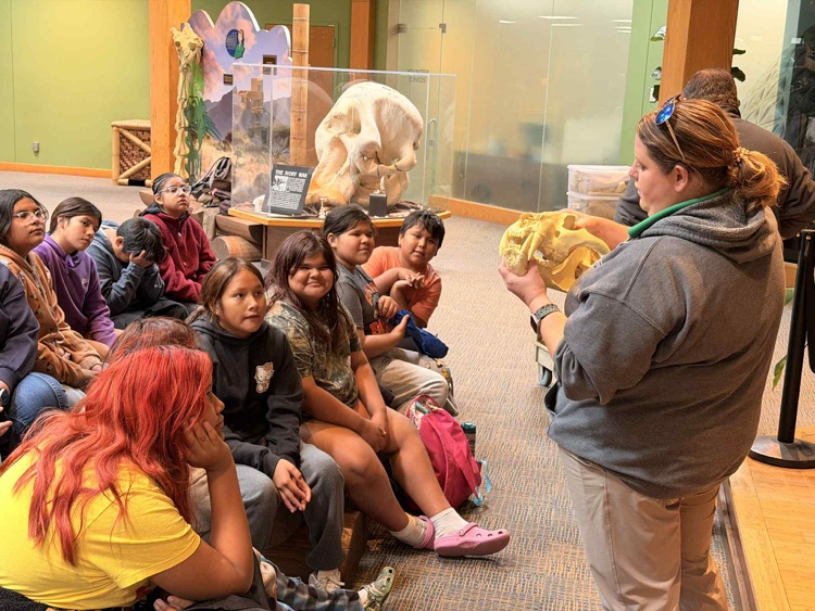 students listening to a presentation in zoo