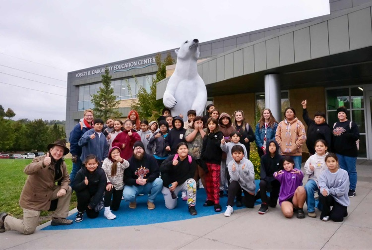 group shot of students in front of a polar bear statue