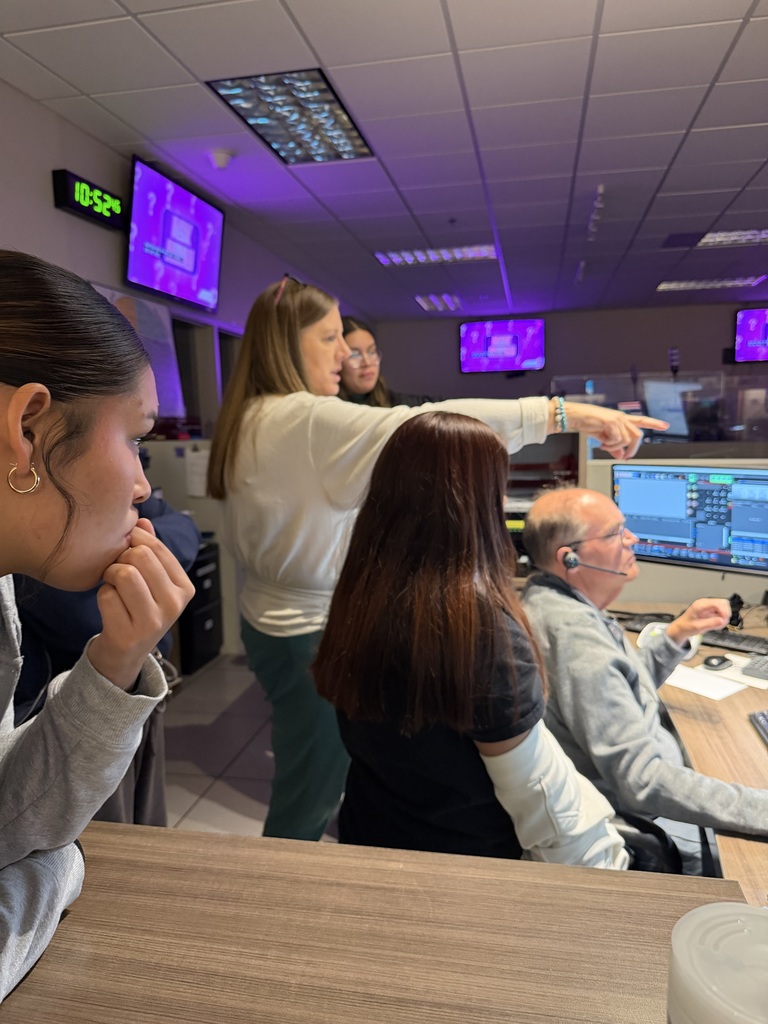 Staff gestures while describing the operations at the Woodbury 911 Communication Center