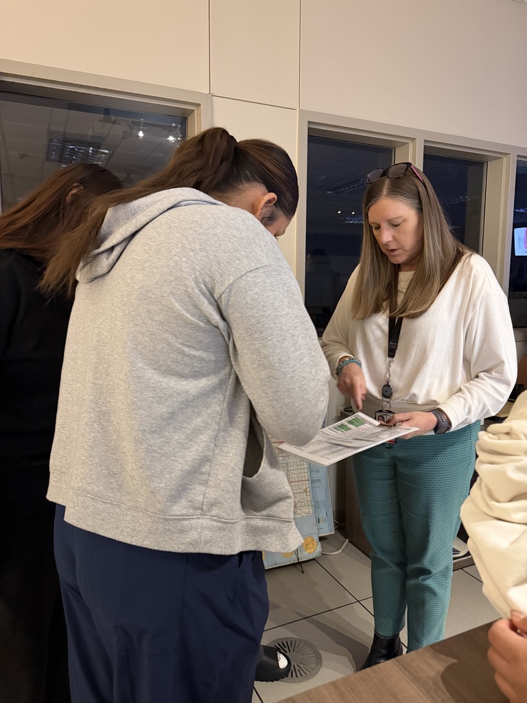 Students review documentation with staff of the Woodbury 911 Communication Center