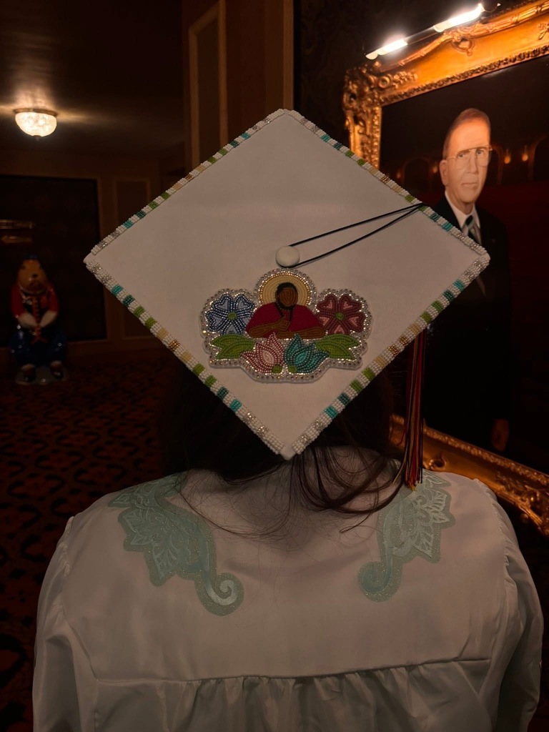 Image of graduation cap decorated with beads.