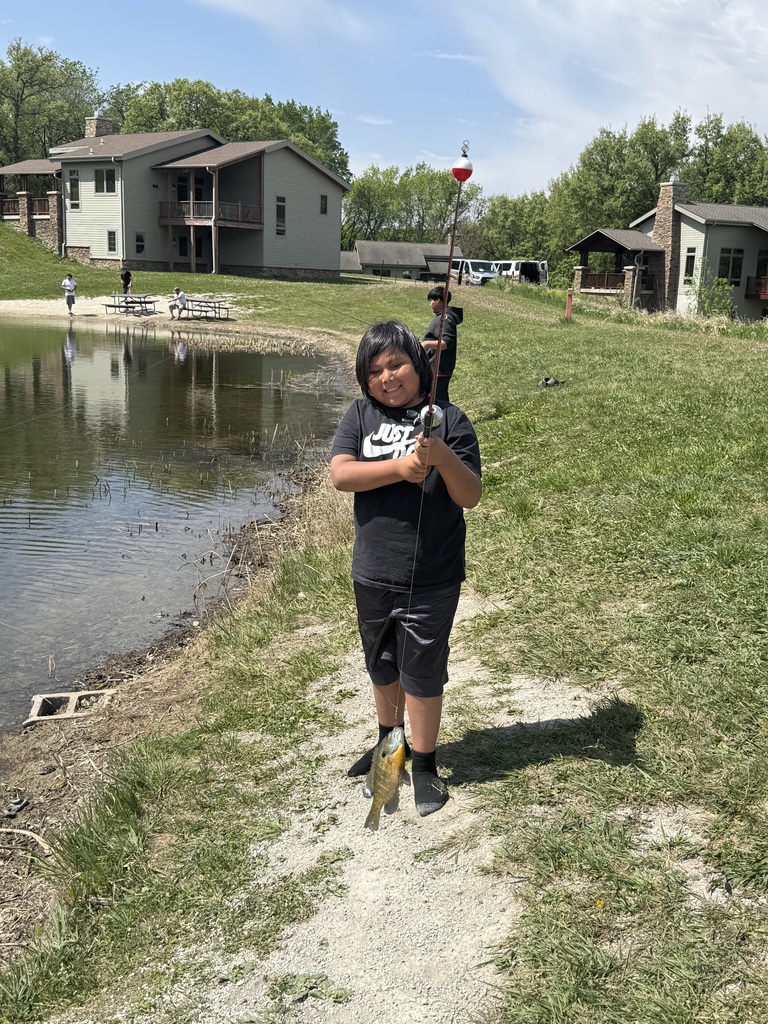 Student holding fishing reel