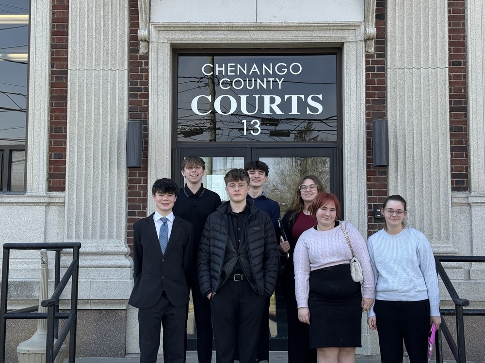 students stand in front of a courthouse