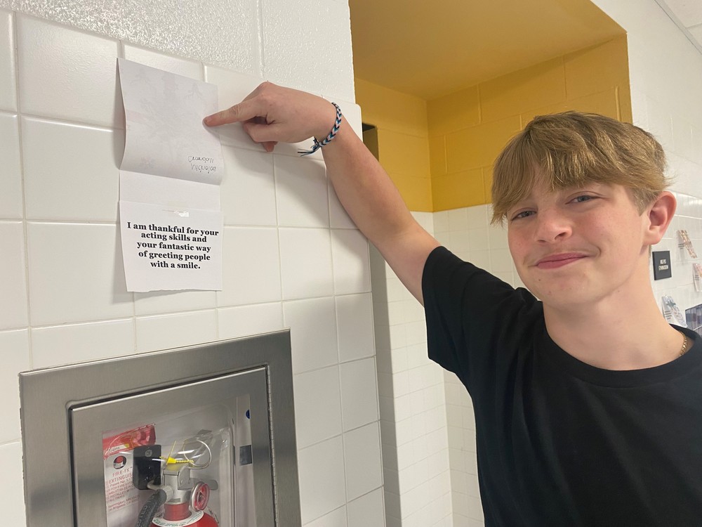 A student points to his card