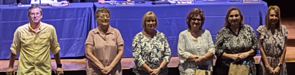 5 women and 1 man standing
