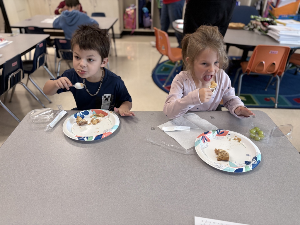 Elementary students enjoying homemade apple treats.