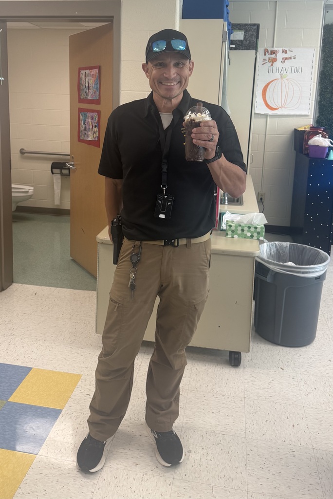 GFJ Staff smiling with a drink in his hand