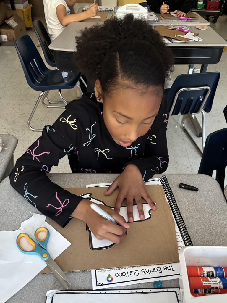 Student drawing the outline of New York State
