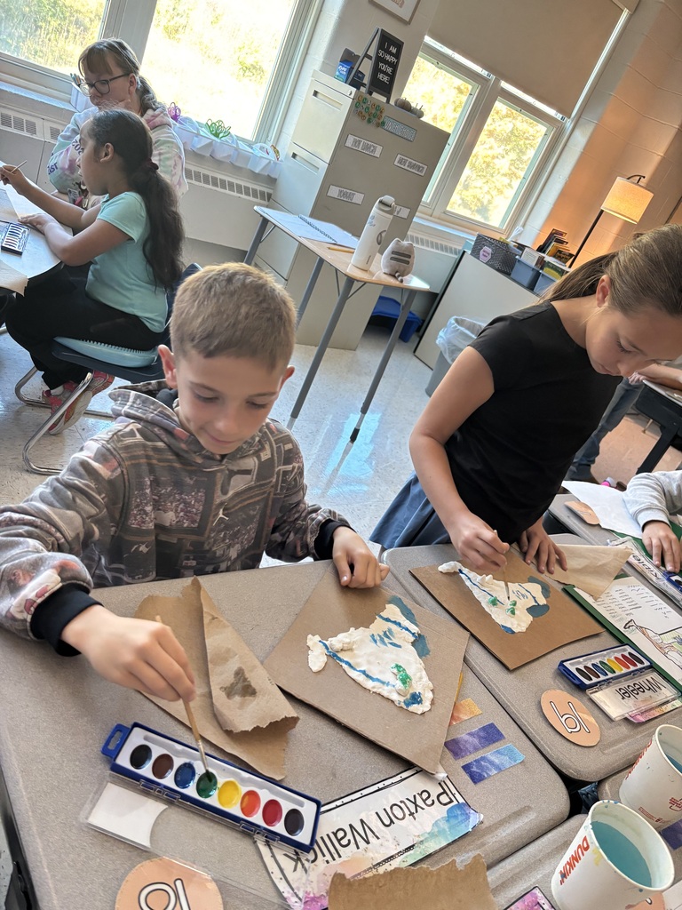 Students painting on their salt dough