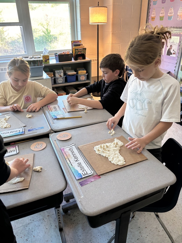 Students forming the salt dough into the shape of New York State