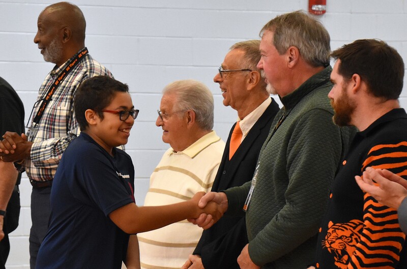 JFS student shaking hands with board member.